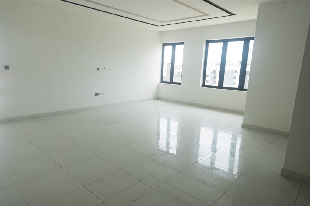 Brum Height 4: Spacious unfurnished living area with large windows